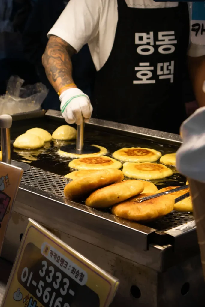 man frying hotteok (Korean sweet pancakes) in Seoul, South Korea